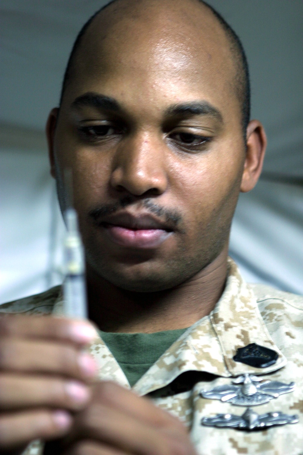 Petty Officer 3rd Class Sadekie K. Carby prepares a vaccination