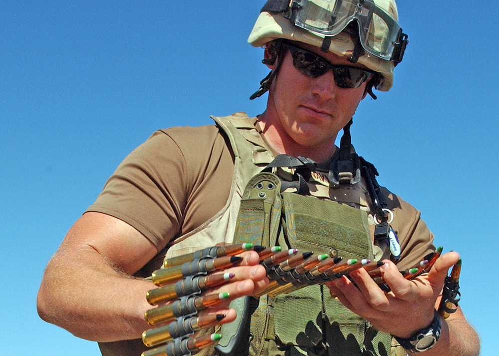 Master-at-Arms 2st Class Matt Tronboll inspects .50 caliber ammunition