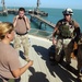 Gunner's Mate 2nd Class Elizabeth Campos gives a safety brief