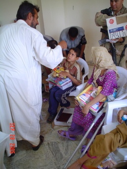 Children wait to be seen by Task Force Baghdad medical personnel
