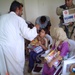 Children wait to be seen by Task Force Baghdad medical personnel