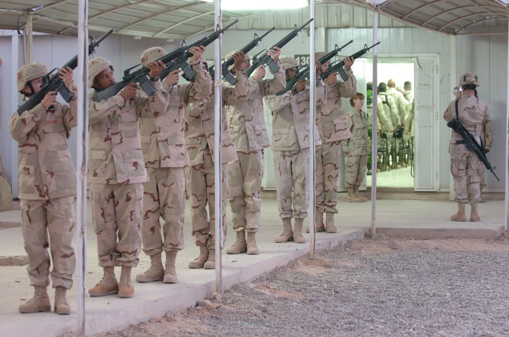 The Brigade Troops Battalion Honor Guard renders a 21-gun salute