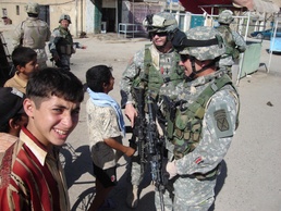 1LT Shelley and MAJ Sullivan talk with Iraqi children in Kadamiyah
