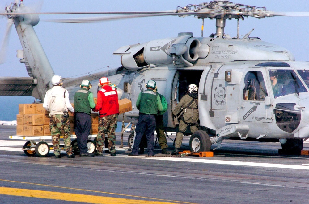 USS Harry S. Truman (CVN 75) Air Department personnel load Meals Ready-to-E