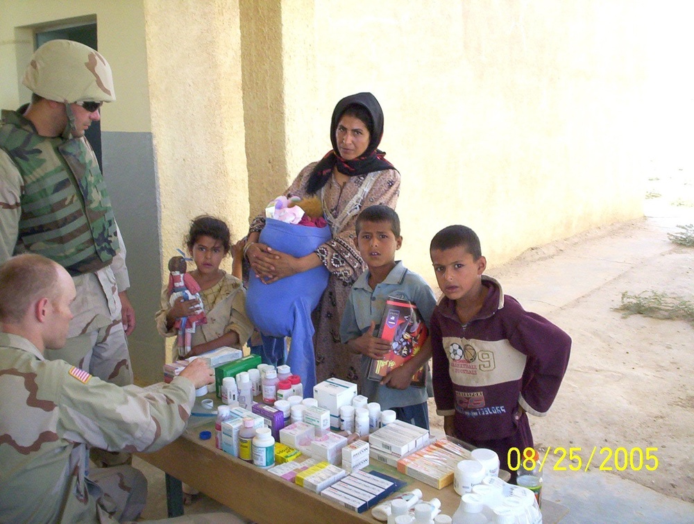 A Task Force 1-163 Infantry pharmacist distributes medication