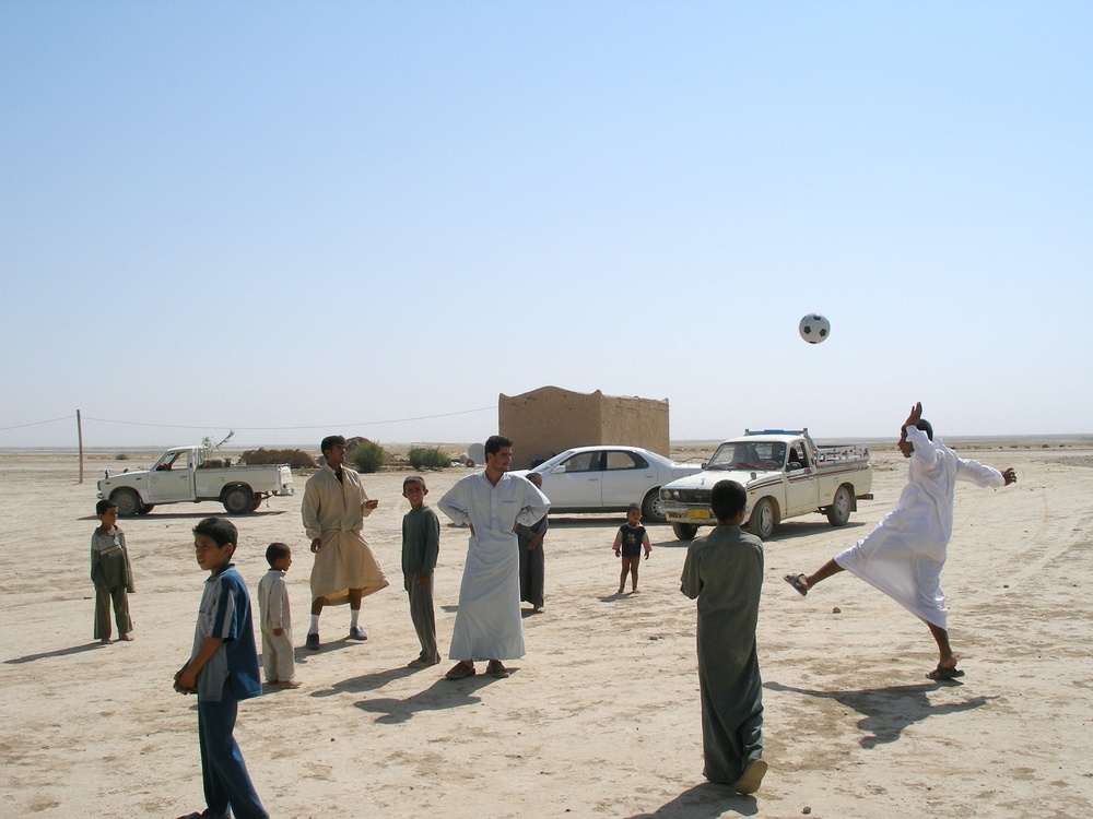 Villagers from Haminariya play with a new soccer ball