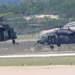 Two UH-60 Blackhawk helicopters prepare for take off
