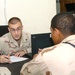 Sgt. Andrzej Kujawski helps a Soldier fill out a power of attorney