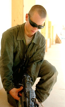 Spc. Douglas Wilson cleans his M-249 machine gun