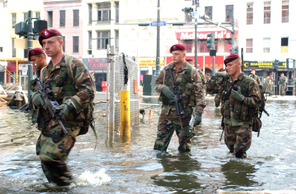 Paratroopers tramp through knee-deep water during a presence patrol