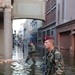 Paratroopers tramp through ankle-high water during a presence patrol