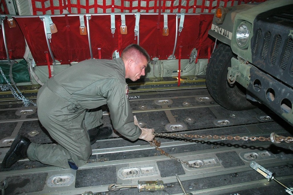 TSGT Gurnan assists in the loading of vehicles in a C-130