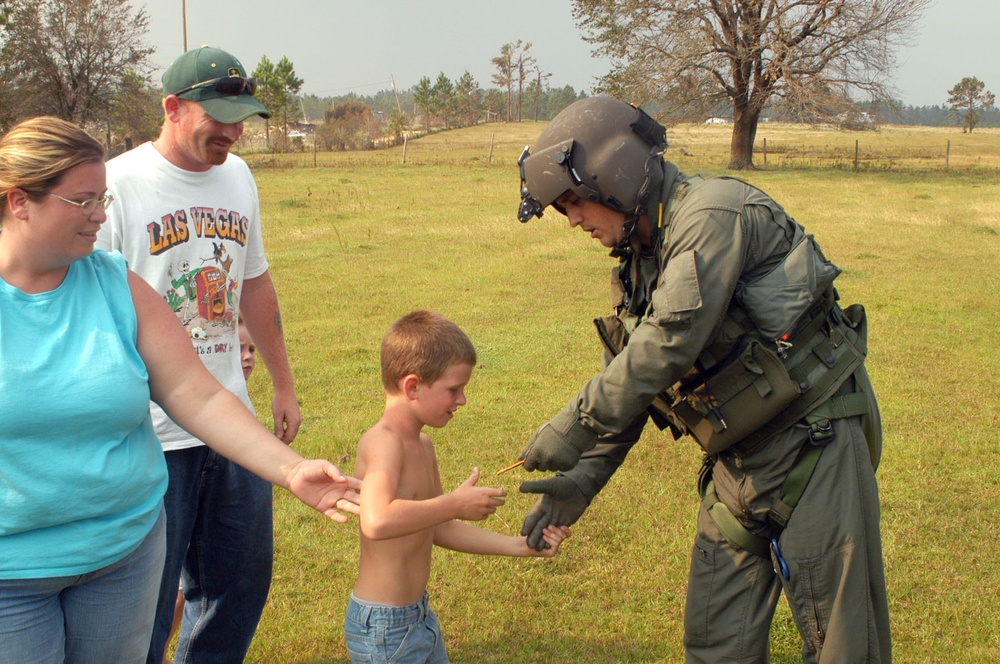 Sgt. Perry Hopman hands a boy an American flag patch