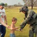 Sgt. Perry Hopman hands a boy an American flag patch