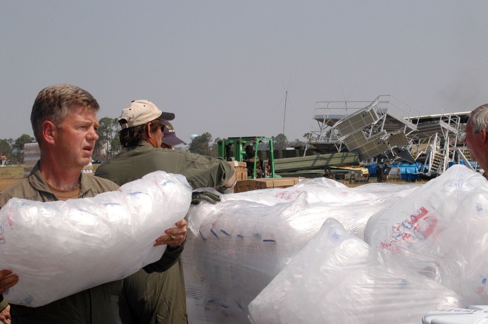 Soldiers and civilians load ice onto pallettes