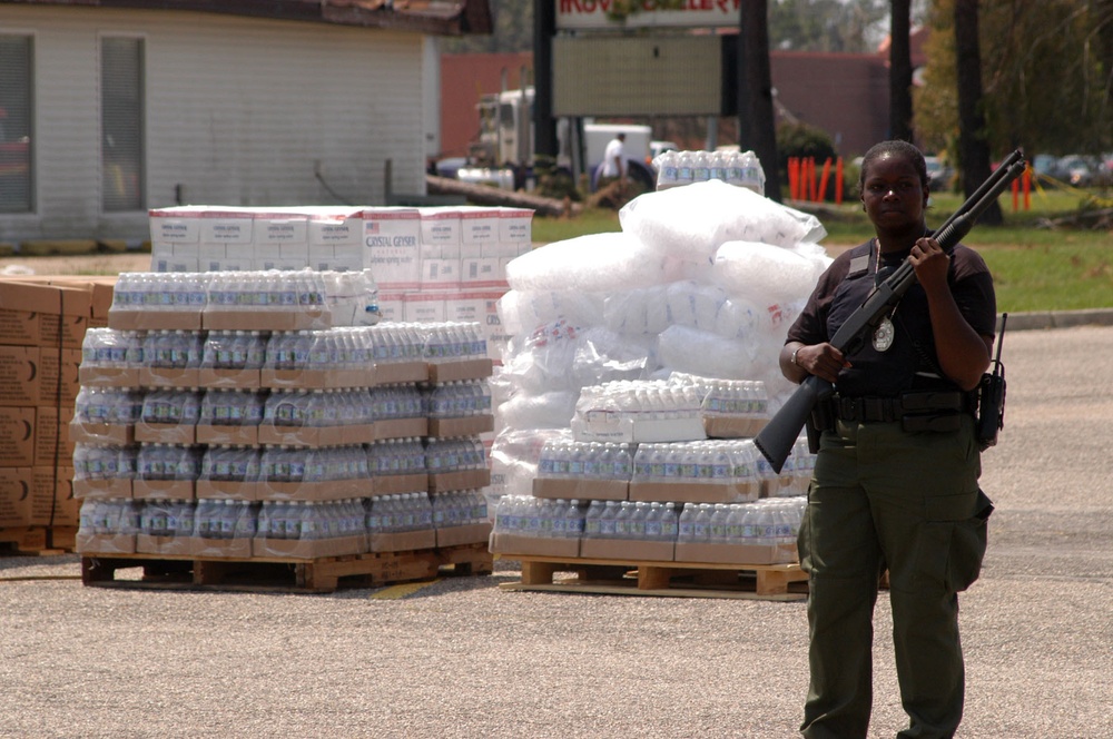 A policewoman guards food supplies