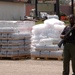 A policewoman guards food supplies