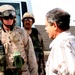 Capt. Jason Belknap greets a Taji area council member after delivering a bu