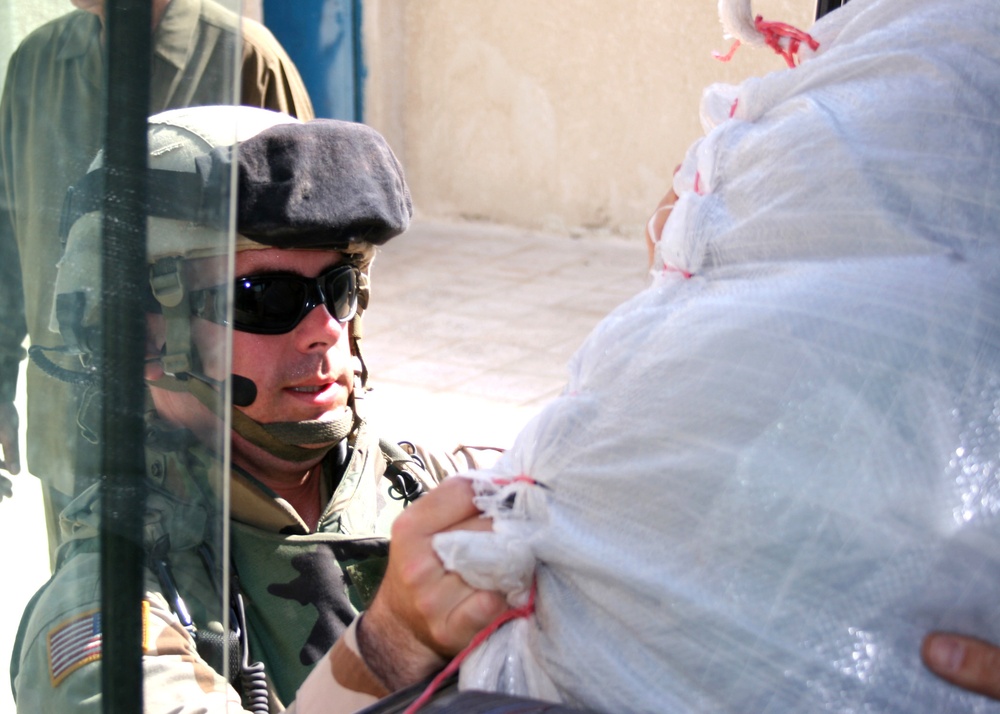 Capt. Hicks delivers the 4,500 school uniforms to Iraqi girls