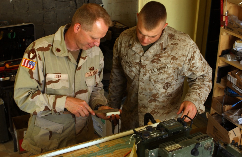 Maj. Cole and Lance Cpl. ryan prepare the parts to build a Q36 space modula