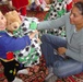 Staff Sgt. Patricia Garcia hands a donated teddy bear wrapped in a donated