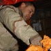 Staff Sgt. Rick Kandrach unloads bags of letters and packages from a mail c