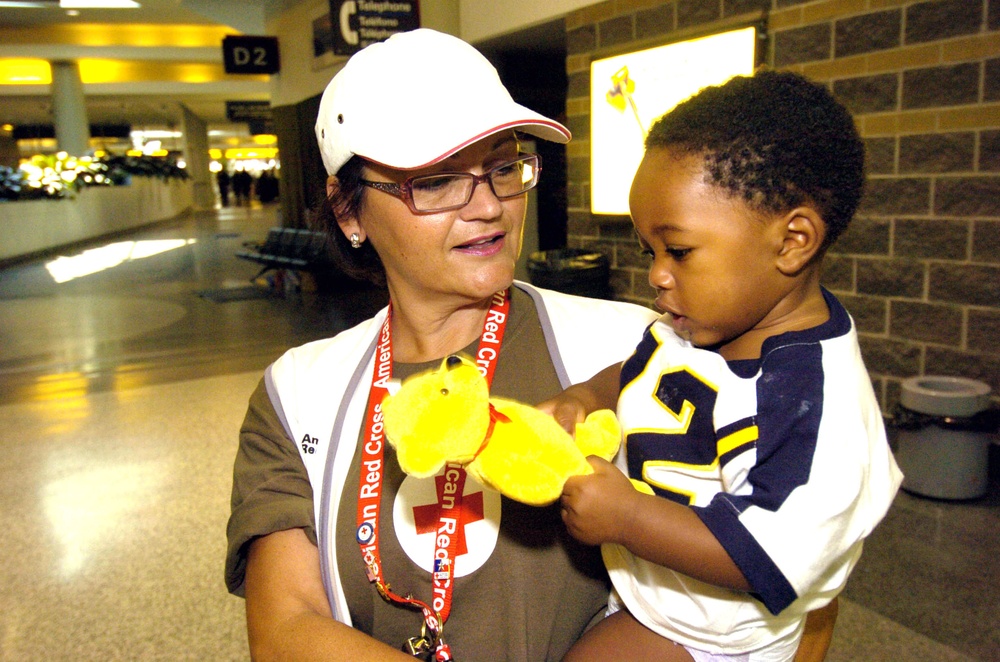 Debbie Alberts of the American Red Cross holds Kaylop who was ev