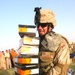 Spc. Charles Richardson carries a stack of new soccer (football) shoes