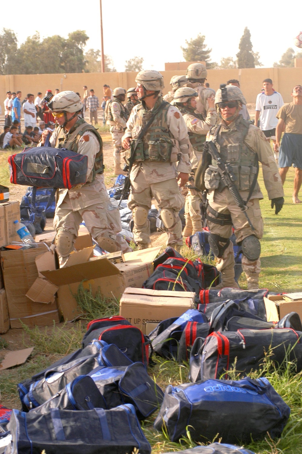 Soldiers unload soccer uniforms and equipment