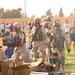 Soldiers unload soccer uniforms and equipment