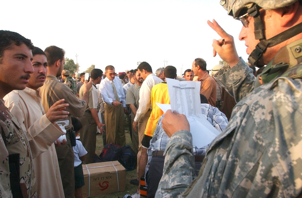 Army Capt. Christopher Ortega discusses the distribution of soccer equipment