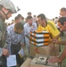 Army Capt. Christopher Ortega oversees the distribution of soccer equipment