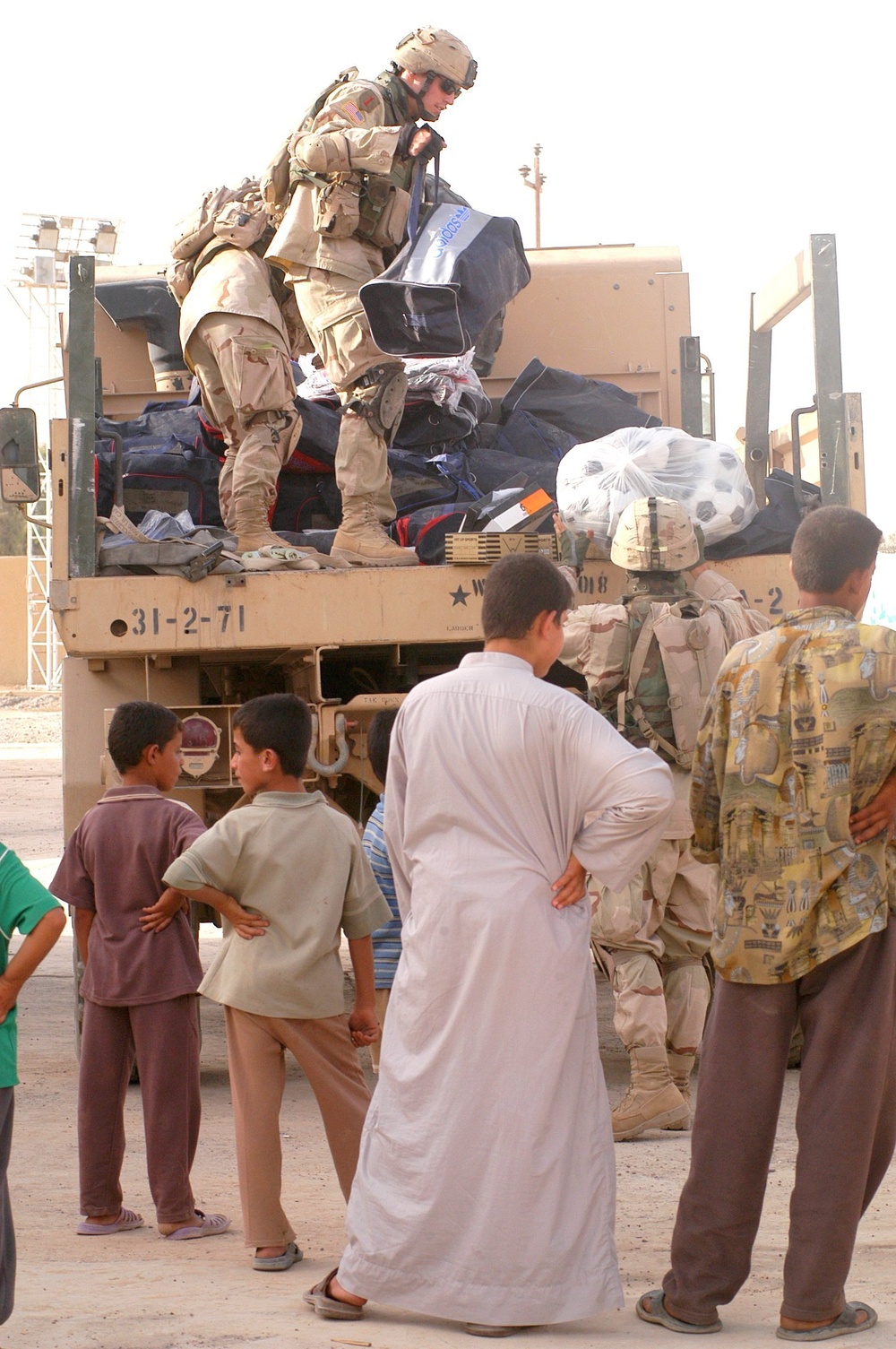 Soldiers unload soccer (football) uniforms and equipment