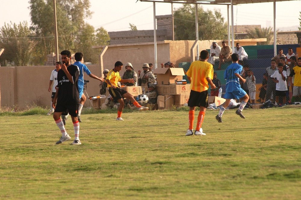 Iraqi boys play soccer (football) using the new uniforms distributed by Coa