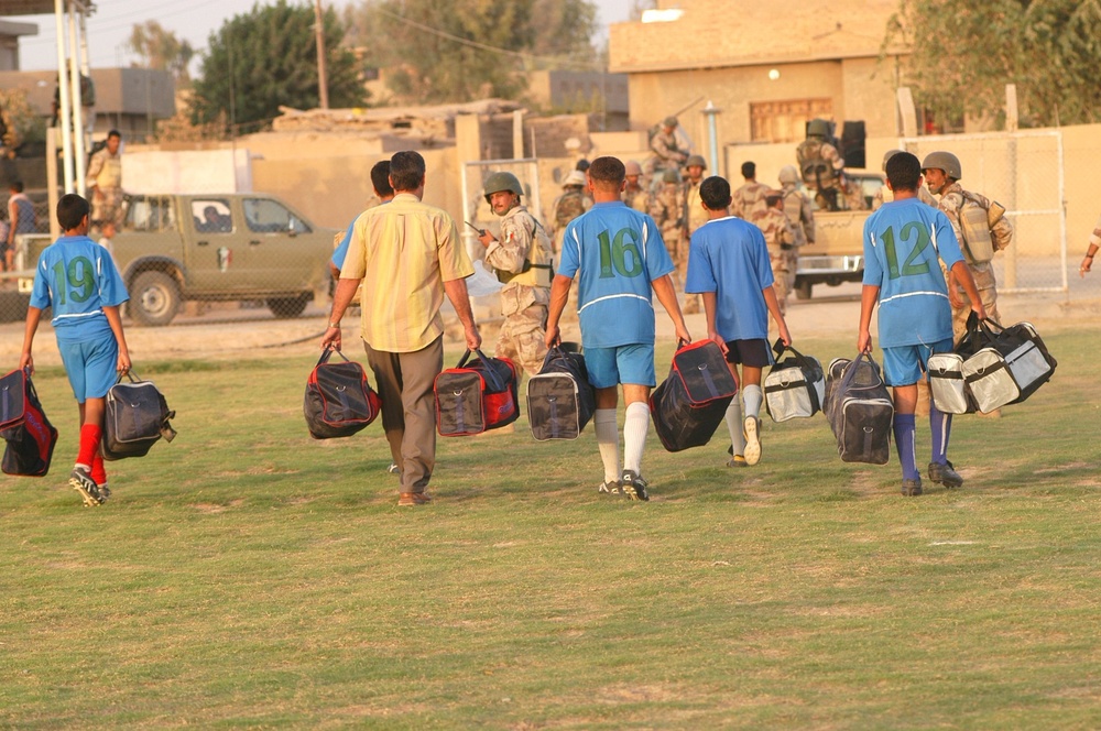Iraqi soccer (football) players leave a soccer stadium where they were give