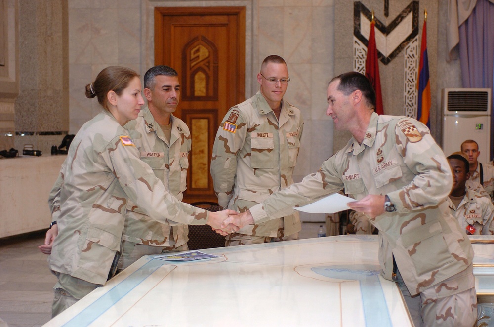 Sergeant Tiffany C. Falk is awarded a commanders coin and certificate