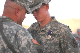 Pfc. Justin Hair is congratulated by his Regiment commander,