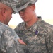 Pfc. Justin Hair is congratulated by his Regiment commander,