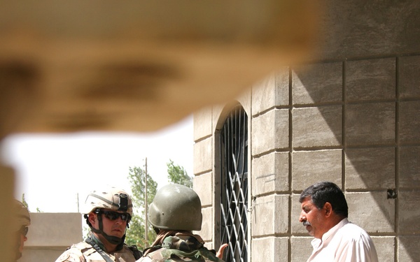 Capt. Jason Foote questions a resident about terrorist activity