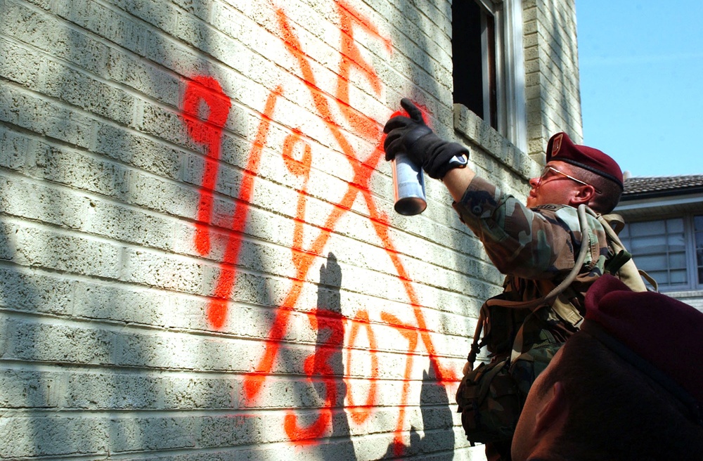 Spc. James O'Reilly marks a flooded home after searching it