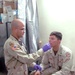 Sgt. Kevin Pantoja checks a Soldiers temperature