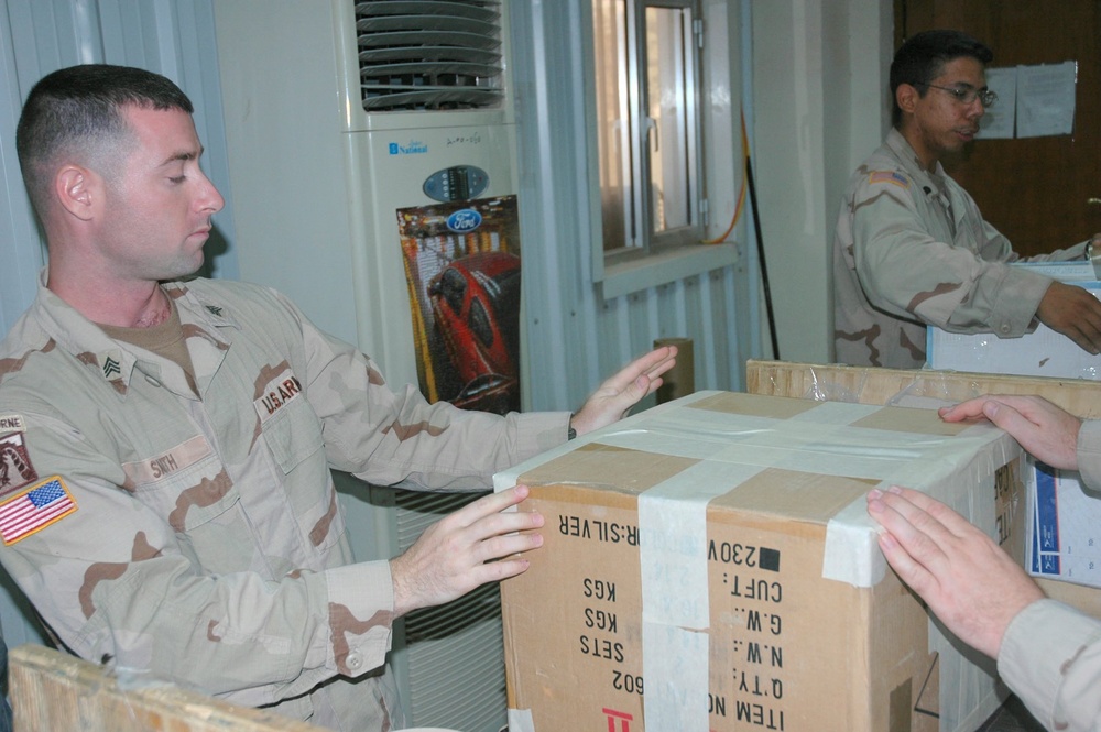 Sgt. Smith seals and labels a fellow Soldiers package to be sent home 1