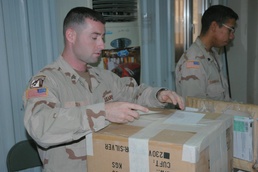 Sgt. Smith seals and labels a fellow Soldiers package to be sent home 3