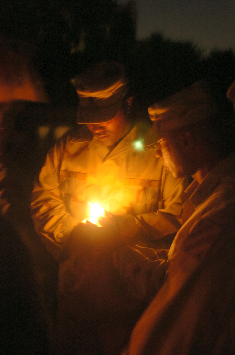 A Task Force Baghdad Soldier holds a candle during the 9/11 remembrance cer