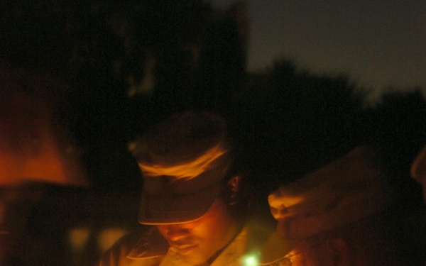 A Task Force Baghdad Soldier holds a candle during the 9/11 remembrance cer