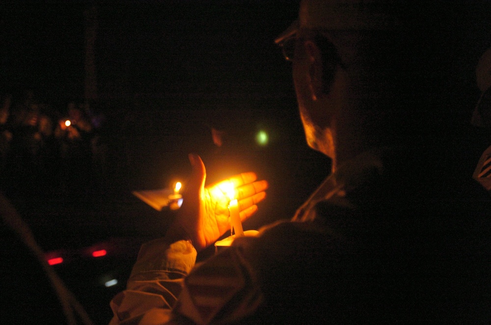 A Task Force Baghdad Soldier holds a candle during the 9/11 remembrance cer