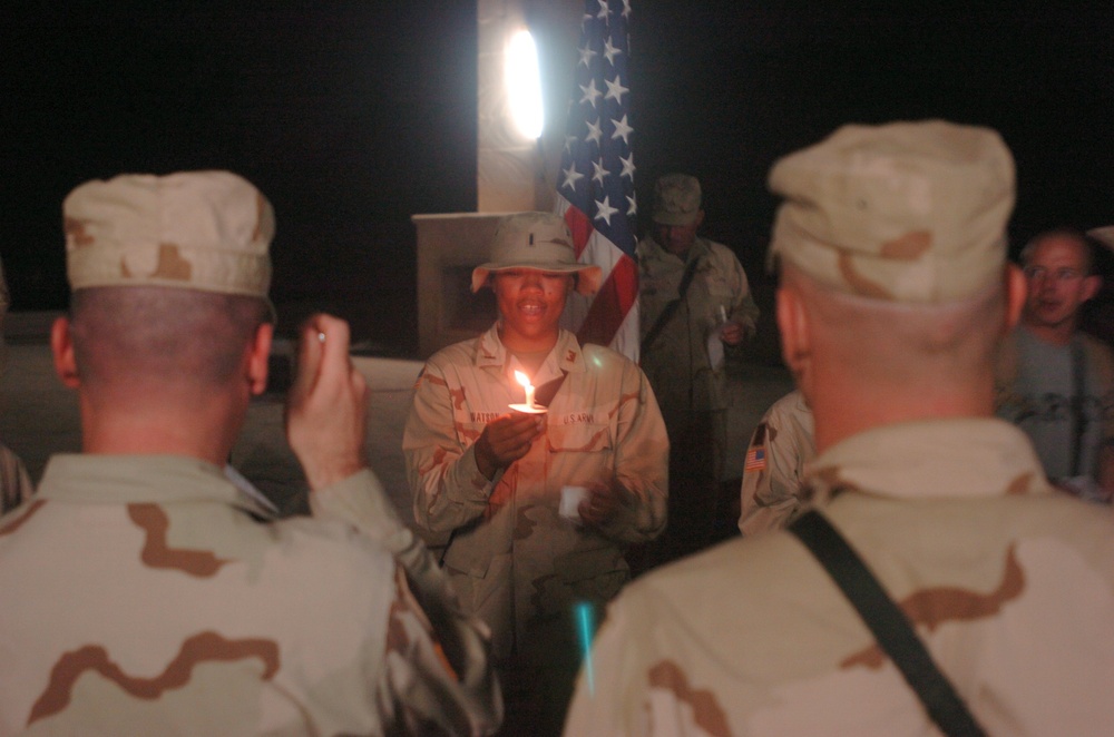 1st Lt. Shenell Watson holds a candle during the 9/11 remembrance ceremony