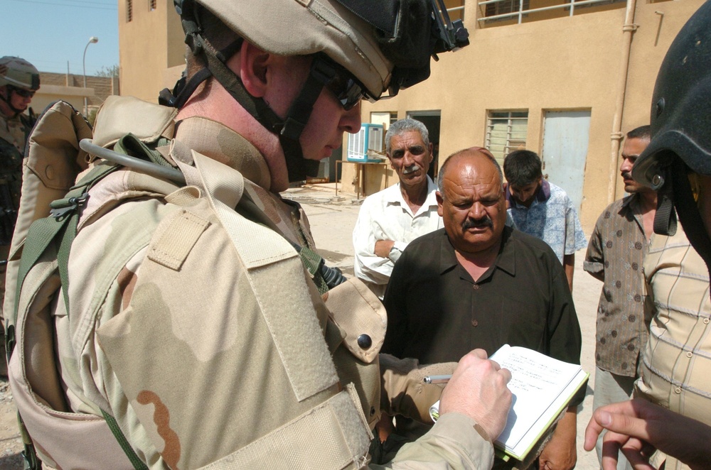 Capt. David Underwood speaks with the manager of the Al Rasheed Water Treat