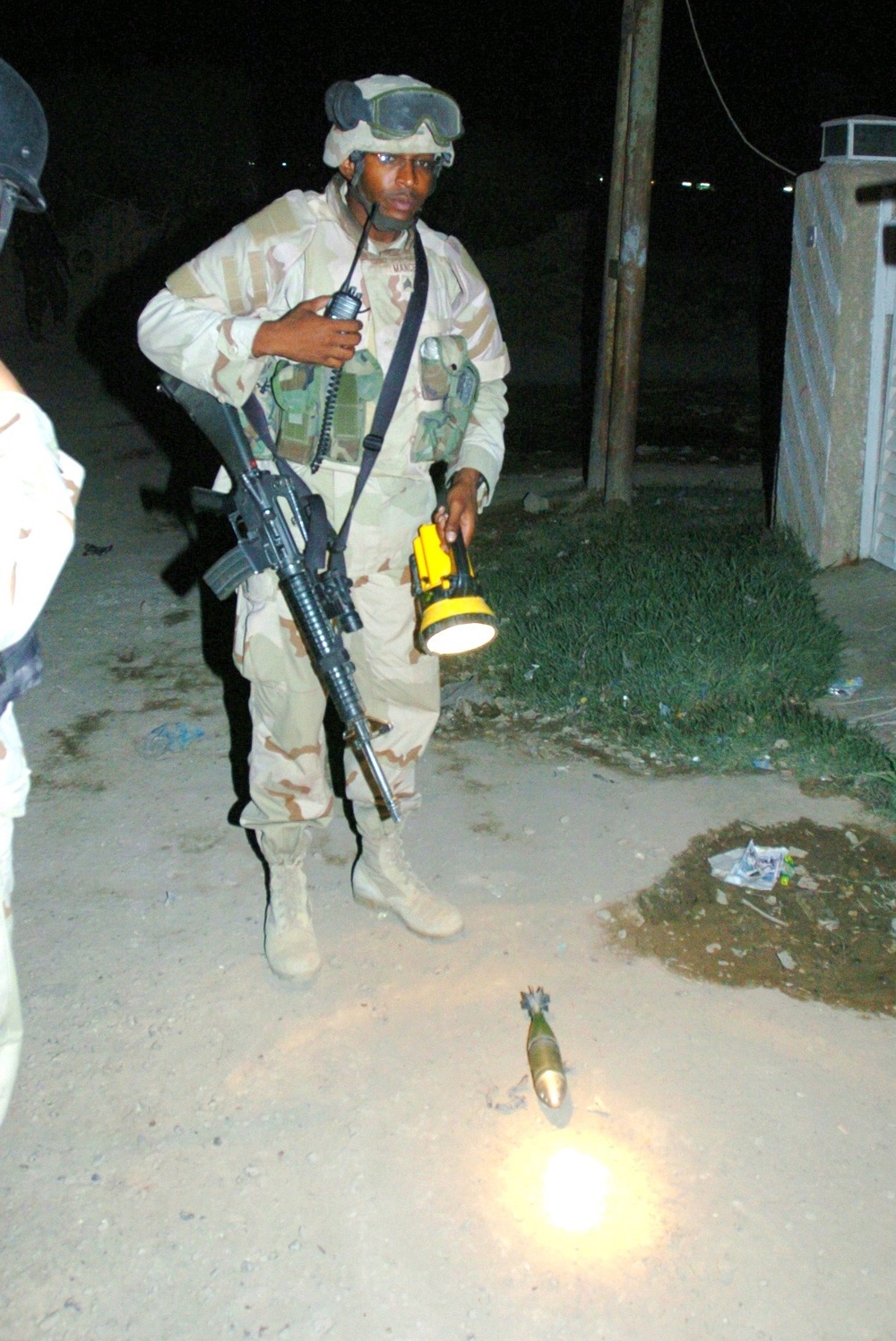 Sgt. Shaun Mance inspects a mortar round found in a Zafarania residence dur