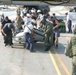 Staff Sgt. Brian Ogle Helps Members of a FEMA Search Team Carry Their Boat